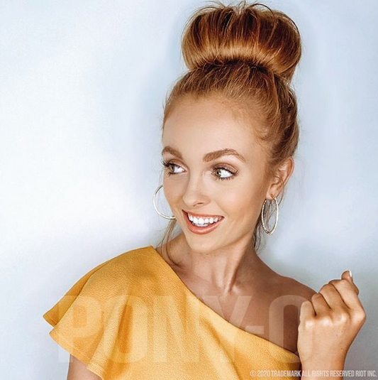 Red haired young woman wearing the BUN BARZ by PONY-O for hair buns, in a fashionable high bun