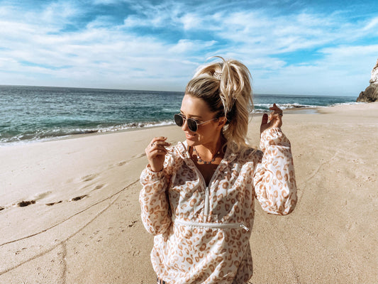 Blonde haired girl at beach, wearing Leopard PONY-O ponytail holder